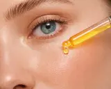 Kropla serum z pipety na skórze. Uważaj na retinol efekty uboczne, jak zaczerwienienie czy suchość.